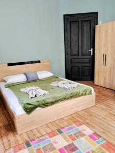 a bedroom with a bed with two towels on it at GuestHouse 4 Karma369 in Plovdiv
