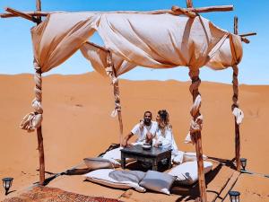 a couple sitting under a tent in the desert at Maria'S Luxury Camp in Merzouga +41 photos