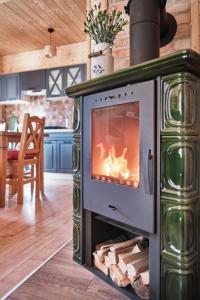 a fireplace in a kitchen with a stove at Domek Sol Wilcza Zagroda in Kudowa-Zdrój
