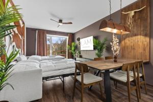 a dining room with a bunch of beds and a table at LAM Western AC in Bratislava