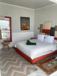 a bedroom with a large bed in a room at Villa grand large in Tamraght Ouzdar