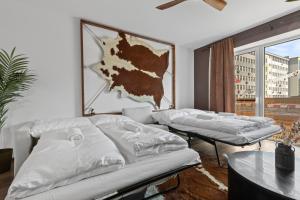 a living room with two beds and a large window at LAM Western AC in Bratislava +6 photos