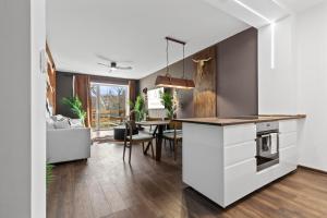 a kitchen and dining room with a white counter top at LAM Western AC in Bratislava