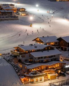a group of people skiing in the snow at night at Leni Mountain Appartements in Sölden +76 photos