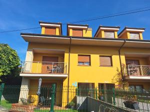 a yellow building with balconies on the side of it at Aldea Bricia 201 in Posada de Llanes