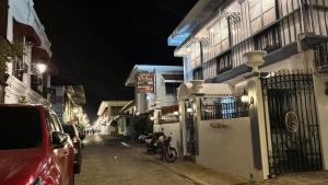 a city street at night with cars parked on the street at Casa Pichay in Vigan