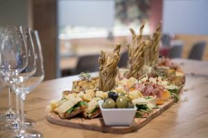 a plate of food on a table with wine glasses at HOTEL&RESTAURANT Rebstock Wolhusen in Wolhusen