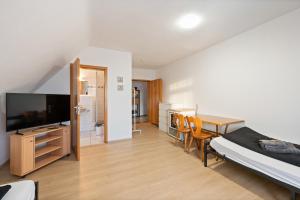 a bedroom with a bed and a desk and a television at Monteurzimmer Haus 6 Nebringen für bis zu 12 Personen - Küche und Parkplätze vorhanden in Gäufelden