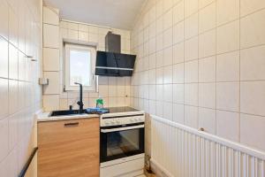 a small kitchen with a sink and a stove at Monteurzimmer Haus 6 Nebringen für bis zu 12 Personen - Küche und Parkplätze vorhanden in Gäufelden +2 photos