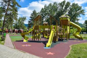 a playground with a slide in a park at Forest Grill in Piatra Neamţ