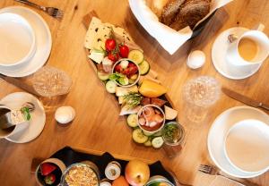a wooden table with a plate of food on it at Leni Mountain Appartements in Sölden