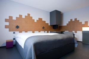 a bedroom with a bed with a large wooden headboard at HOTEL&RESTAURANT Rebstock Wolhusen in Wolhusen