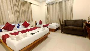 a hotel room with a large bed and a chair at Hotel Edition Blue in Mumbai +34 photos