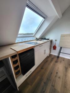 a kitchen with a sink and a window at L'escapade ansérienne in Oye-Plage