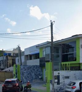 a man sitting on a motorcycle in front of a building at Hostel Suites in Recife