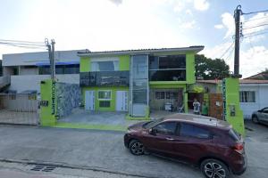 a red car parked in front of a house at Hostel Suites in Recife +3 photos
