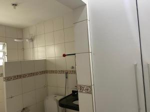 a small bathroom with a toilet and a mirror at Hostel Suites in Recife