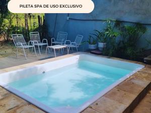 a large rectangle pool with chairs and chairs around it at Alojamiento Mariana y Ocho Oñondive in Villa Concepción +3 photos