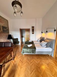 a bedroom with a bed and a wooden floor at Apartament Rynek 20 in Krosno