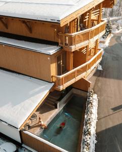 a house with a swimming pool in front of it at Leni Mountain Lodge in Sölden +93 photos