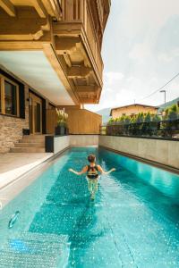 a woman in a swimming pool in a house at Leni Mountain Lodge in Sölden