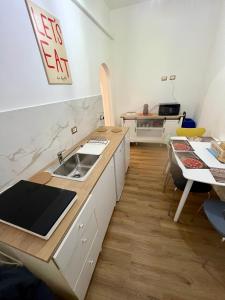 a kitchen with a sink and a counter top at Saffi Rooms in Civitavecchia
