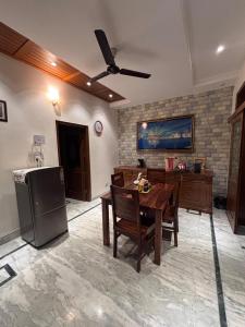 a kitchen with a table and a refrigerator at Serene Stay 22 in Chandīgarh