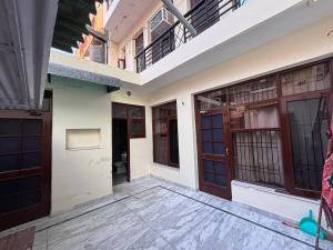 a building with wooden doors and a balcony at Serene Stay 22 in Chandīgarh