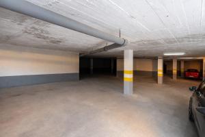 an empty parking garage with a car parked in it at Dreams house elia in Budva