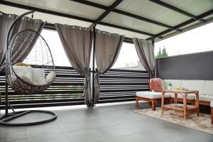 a room with black and white striped walls and swings at Apartman Incerum in Požega