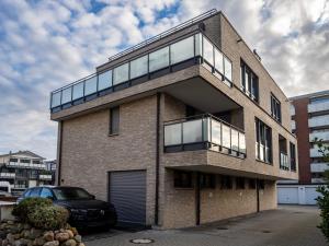 a brick building with a balcony on top of it at Strandgutresidenz in Westerland