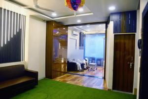 a living room with a couch and a room with a table at Hotel Edition Blue in Mumbai