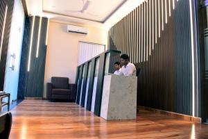 two men standing at a counter in a lobby at Hotel Edition Blue in Mumbai
