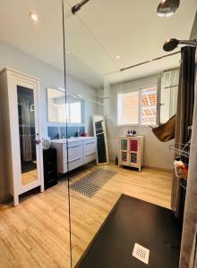a bathroom with a glass shower and a sink at La Perla in Mont-de-Marsan