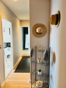 a hallway with a shelf with plants on it at La Perla in Mont-de-Marsan +5 photos