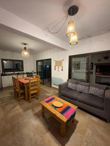 a living room with a couch and a table at Moller masi inti wayra in Purmamarca +12 photos