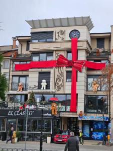 a building with a red ribbon and a red bow at Alo Alo Apartman 5 in Kruševac