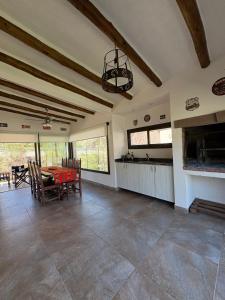 a large living room with a table and a kitchen at Moller masi inti wayra in Purmamarca