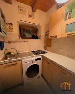 a kitchen with a sink and a washing machine at La casa di Agnese by Homes in Ancona in Ancona
