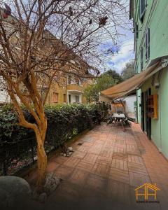 a patio with a tree next to a building at La casa di Agnese by Homes in Ancona in Ancona +10 photos
