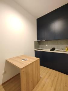 a kitchen with a wooden table and a counter top at 369 Apartments in Belgrade +7 photos