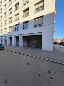 an empty parking lot in front of a building at Apartament Skarbowa East in Leszno