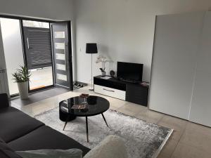 a living room with a couch and a table at Apartman 4N with free parking in Belgrade