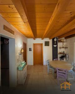 a kitchen with a wooden ceiling and a table at La casa di Agnese by Homes in Ancona in Ancona