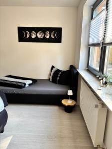 a living room with a couch and a window at Ferienwohnung LeJaju in Friedrichsthal