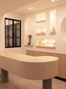 a waiting room with a round table and a window at Blue Sea Boutique Apartments in Olympic Beach
