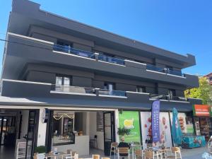a building with tables in front of it at Blue Sea Boutique Apartments in Olympic Beach