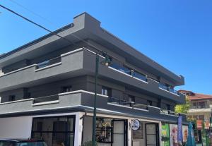an apartment building with a black facade at Blue Sea Boutique Apartments in Olympic Beach