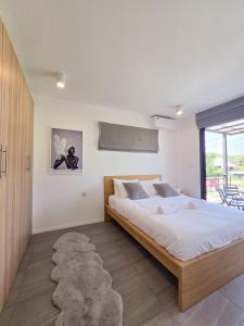 a bedroom with a large bed and a rug at AURA STAY-Luxury Private Pool Villa walk to Kad Farang in Chiang Mai +27 photos