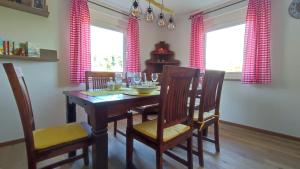 a dining room with a wooden table and chairs at Ferienhaus Rudolf in Achberg